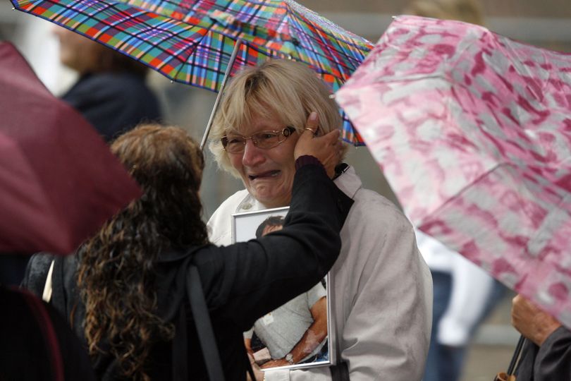  A woman is comforted as friends and relatives of the victims of the Sept. 11, 2001 attacks gather for a commemoration ceremony at Zuccotti Park, adjacent to ground zero, on the eighth anniversary of the terrorist attacks on the World Trade Center, Friday, Sept. 11, 2009 in New York.  (Jason Decrow / Associated Press)