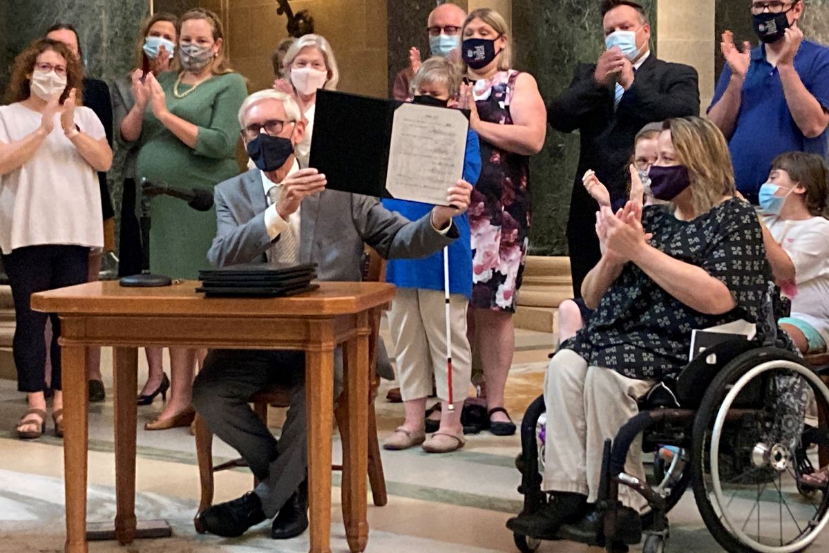 Wisconsin Gov. Tony Evers vetoes Republican bills that would have made it more difficult to vote absentee in the battleground state during a news conference in the Capitol rotunda on Tuesday, Aug. 10, 2021, in Madison, Wis.  (Scott Bauer)