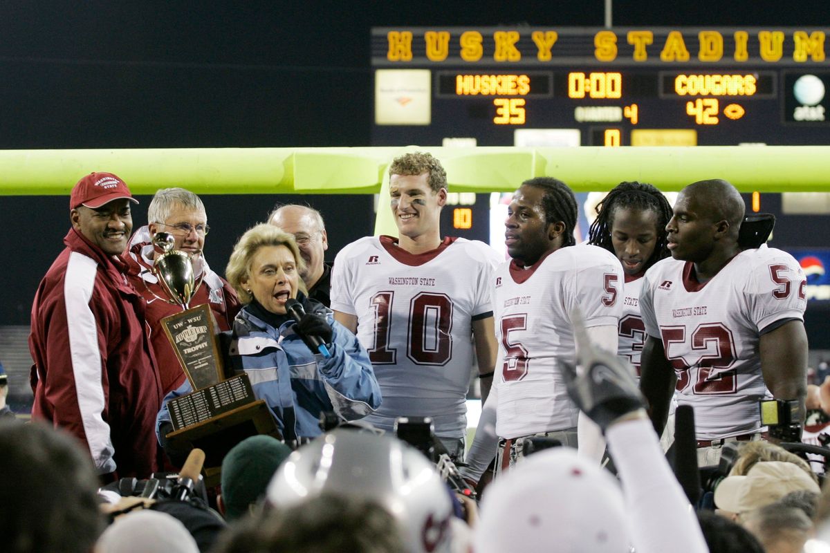 Washington Gov. Chris Gregoire presents the Apple Cup trophy to (from left) Washington State president Elson Floyd, head coach Bill Doba, and players Alex Brink, Michael Bumpus, Husain Abdullah and Nick Cantlon, following WSU’s 42-35 win over Washington in the Apple Cup on Nov. 24, 2007, at Husky Stadium in Seattle.  (Associated Press)