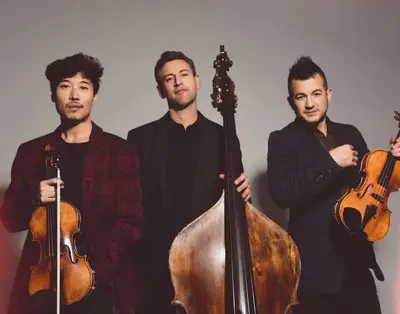 Charles Yang (violin, vocals), Ranaan Meyer (double bass, vocals) and Nicolas “Nick” Kendall (violin, vocals) are Time for Three, the Grammy Award-winning trio that will join Zuill Bailey at Classics Northwest this weekend.  (Courtesy)