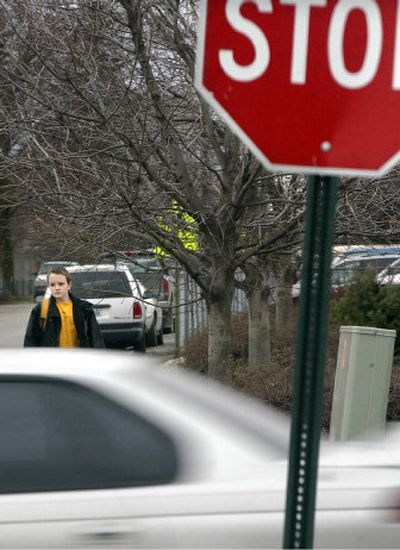 
West Valley City School eighth-grader Ben Wikle heads for the bus stop at Argonne Road and Valleyway Avenue in Spokane Valley on Tuesday. Wikle uses the crosswalk every morning on his way to school. Students from West Valley's City School are working on getting a pedestrian-activated crosswalk installed at that intersection. 
 (Liz Kishimoto / The Spokesman-Review)
