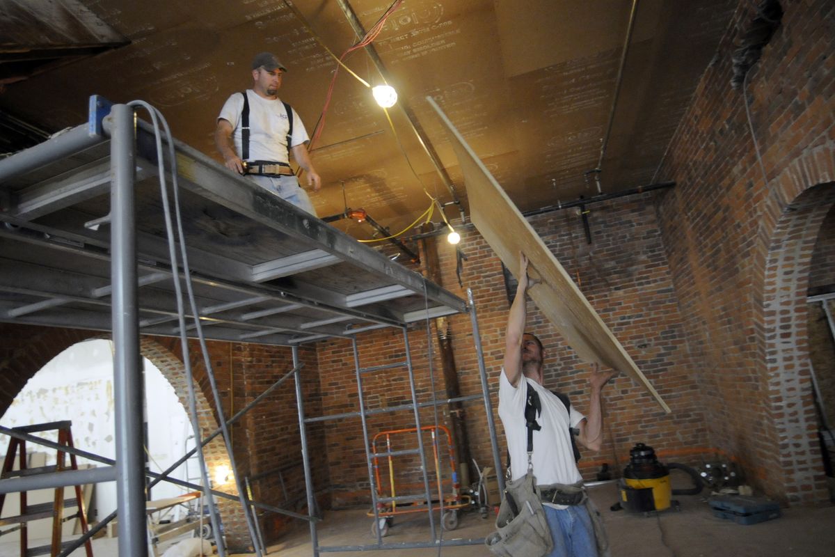 Construction workers Don Gearhart, below, and Bart Provancha install sheets of soundproofing material on the ceiling of Post Street Ale House, a pub that is expected to open in the Hotel Lusso. Walt Worthy, owner of the Davenport Hotel and Davenport Hotel Tower, recently bought Hotel Lusso and plans to reopen it in mid-September. (Colin Mulvany / The Spokesman-Review)