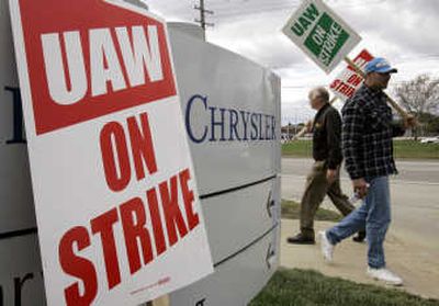 
United Auto Workers members carry strike signs outside the Chrysler Warren Stamping facility during a brief strike in Warren, Mich., on Wednesday.Associated Press
 (Associated Press / The Spokesman-Review)