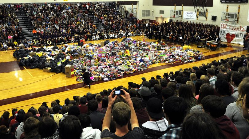 The gym floor was covered with donated toys during an assembly in honor of McKenzie Mott and Josie Freier at University High School on Friday, October 11, 2013. Mott and Freier were killed in a car accident Saturday October 5, 2013. (Kathy Plonka)