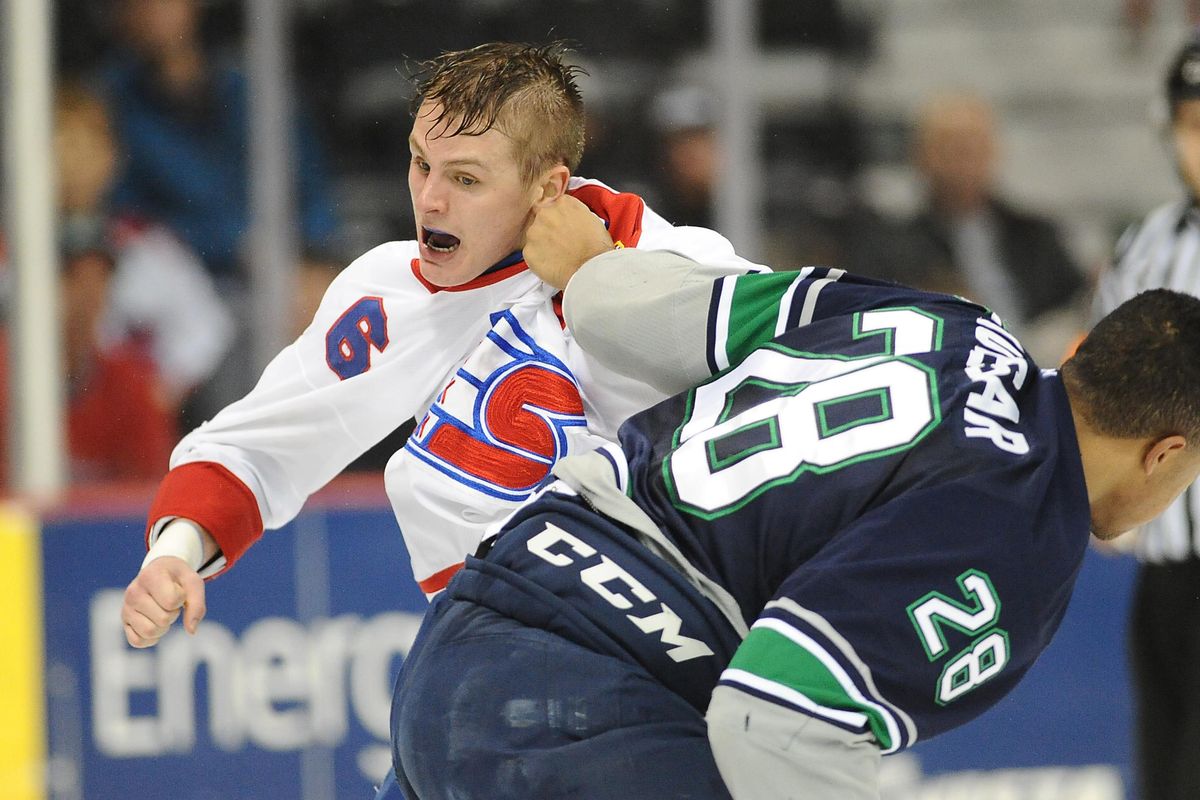 Spokane Chiefs defenseman Tyson Helgesen, left, exchanges punches with Seattle Thunderbirds right wing Keegan Kolesar during the first period Wednesday at the Arena. (James Snook / James Snook Special to The Spokesman-Review)