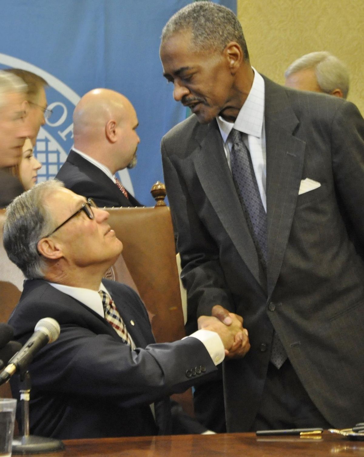 Gov. Jay Inslee shakes hands with WSU President Elson Floyd in April 2015 after the signing of the bill giving the university the legal authority to start its own medical school. (Jim Camden / The Spokesman-Review)