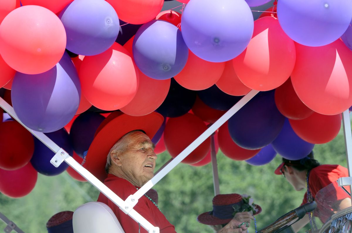 John Cook rides in the helmsman’s seat on a boat used as a float for Generations Assisted Living and Wellness in the Rathdrum Days Parade on Saturday in Rathdrum. Cook is a resident at Generations. (Jesse Tinsley / The Spokesman-Review)