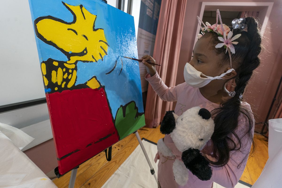 Kaley Williams, 8, paints a panel of a “Peanuts” mural that will be placed in the outpatient pediatric floor of One Brooklyn Health at Brookdale Hospital, Thursday, in the Brooklyn borough of New York.  (Associated Press)