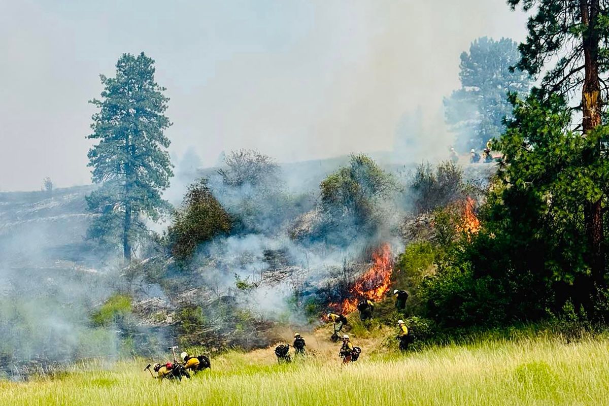 Firefighters battle to contain a blaze between Kettle Falls and Northport, Wash.  (Courtesy)
