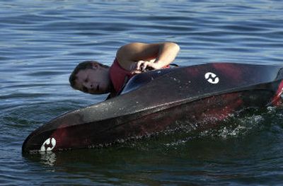 
Kayaking class student Dawson Mosey  rolls his boat in the water near North Idaho College beach to practice escaping from an inverted kayak. He was taking a beginners' whitewater kayak class from the college's Outdoor Pursuits program. 
 (The Spokesman-Review)