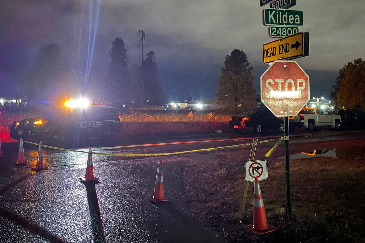 Kildea and Glenarvon roads is closed off with crime scene tape Saturday night in Otis Orchards after Liberty Lake police shot a person.  (Garrett Cabeza / The Spokesman-Review)