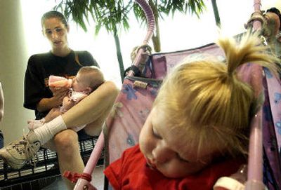 
Alexandria Campbell feeds 4-month-old McKinzie, while her other daughter, Jaiyden, naps Tuesday at the STA Plaza in Spokane. Campbell admits to smoking during her three pregnancies but insists she steps out of the house now to light up. 
 (Brian Plonka / The Spokesman-Review)