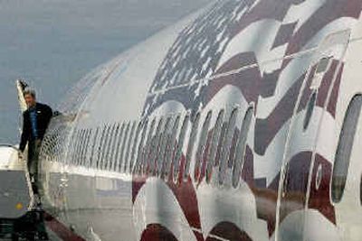 
Democratic presidential candidate Sen. John Kerry, D-Mass., exits his plane after landing at Washington National Airport in Washington, D.C., Sunday. The flag at right was added to his plane over the weekend. 
 (Associated Press / The Spokesman-Review)
