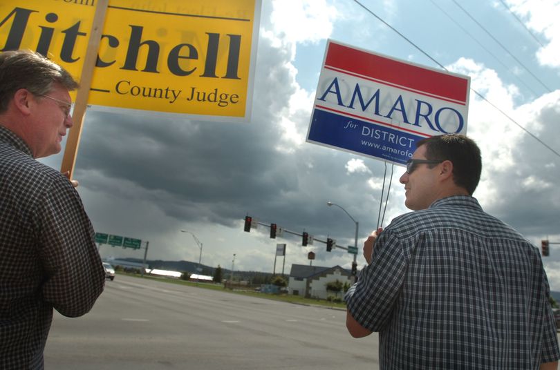 Duane Rasmussen, left, and Lance Amaro chat during a lull in the traffic at the corner of Appleway and U.S. 95 in Coeur d'Alene Tuesday, May 23, 2006 while campaigning for opposing candidates, Judge John Mitchell and Amaro's wife, challenger Rami Amaro.  Other candidates and supporters held signs around Kootenai County Tuesday, primary election day in Idaho.    Jesse Tinsley The SPOKESMAN-REVIEW (Jesse Tinsley / The Spokesman-Review)