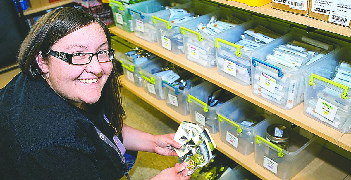 Amanda Choquette, assistant manager at Green Star Cannabis, stocks inventory.  (Courtesy Kim Miller / PictureMyProperty.net)