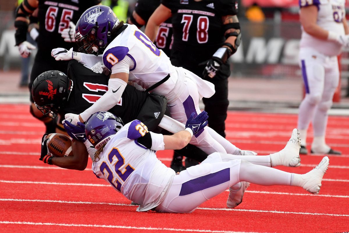 After a first-down reception, Eastern Washington wide receiver Freddie Roberson (11) is tackled by Northern Iowa defensive back Jevon Brekke (0) and Northern Iowa linebacker Bryce Flater (22) during a FCS college football playoff game, Saturday, Nov. 27, 2021, on Roos Field in Cheney, Wash.  (COLIN MULVANY/THE SPOKESMAN-REVIEW)