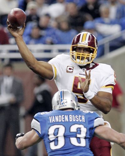 Redskins’ Donovan McNabb, top, was surprised at being benched against Kyle Vanden Bosch and Lions. (Associated Press)