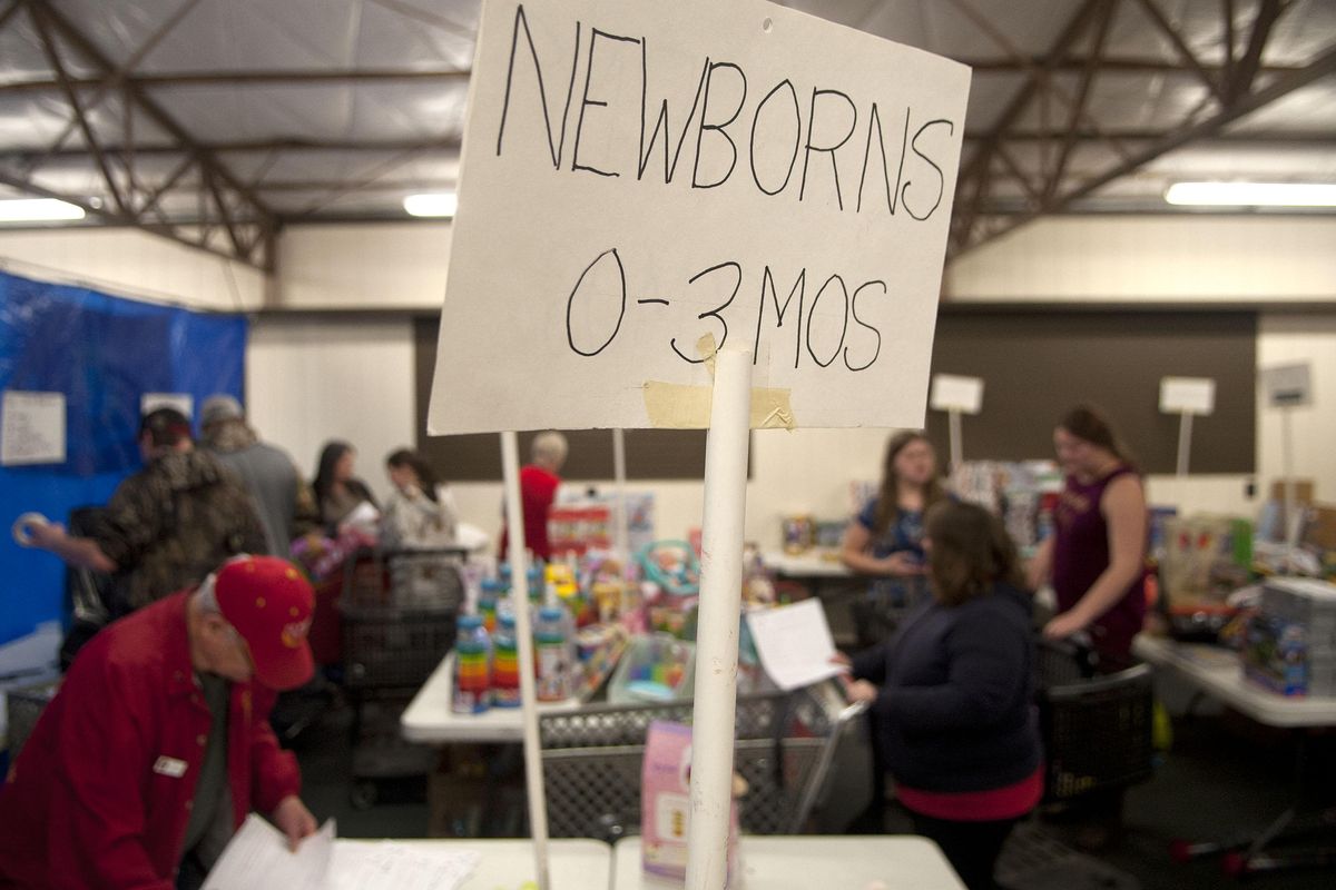 Volunteers work at CDA Toys for Tots at Kootenai County Fairgrounds on Tuesday, Dec.4, 2018. They lost their biggest donor, Toys R Us, and are hoping for more donations. (Kathy Plonka / The Spokesman-Review)