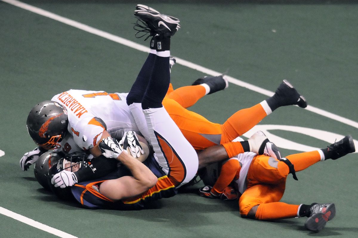 Spokane Shock  Andy Olson (7) gets crunched by Boise