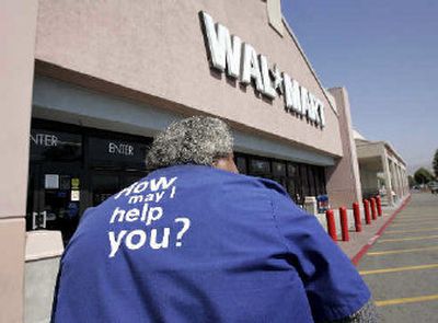 
A Wal-Mart employee walks into a Wal-Mart store in Milpitas, Calif. Wal-Mart Stores Inc., the world's largest retailer, posted its first profit decline in a decade as second-quarter earnings fell 26 percent due to the cost of selling its Germany operation. 
 (Associated Press / The Spokesman-Review)