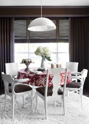Interior designer Brian Patrick Flynn created this dining room for HGTV.com by updating mismatched flea market chairs with the same color spray paint and cushion fabric for a high-end look on a tight budget.  (Associated Press)