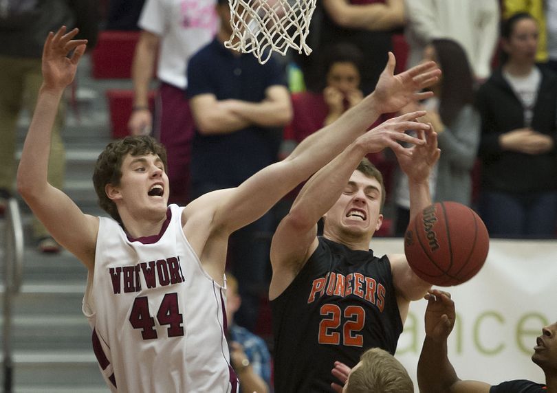 Whitworth Pirates Adam Wilks (44) and Lewis & Clark  guard Connor Freeberg (22) compete for a rebound during the first half of a Northwest Conference Tournament Semifinal at Whitworth Fieldhouse, Thursday, Feb. 27, 2014. (Colin Mulvany / The Spokesman-Review)