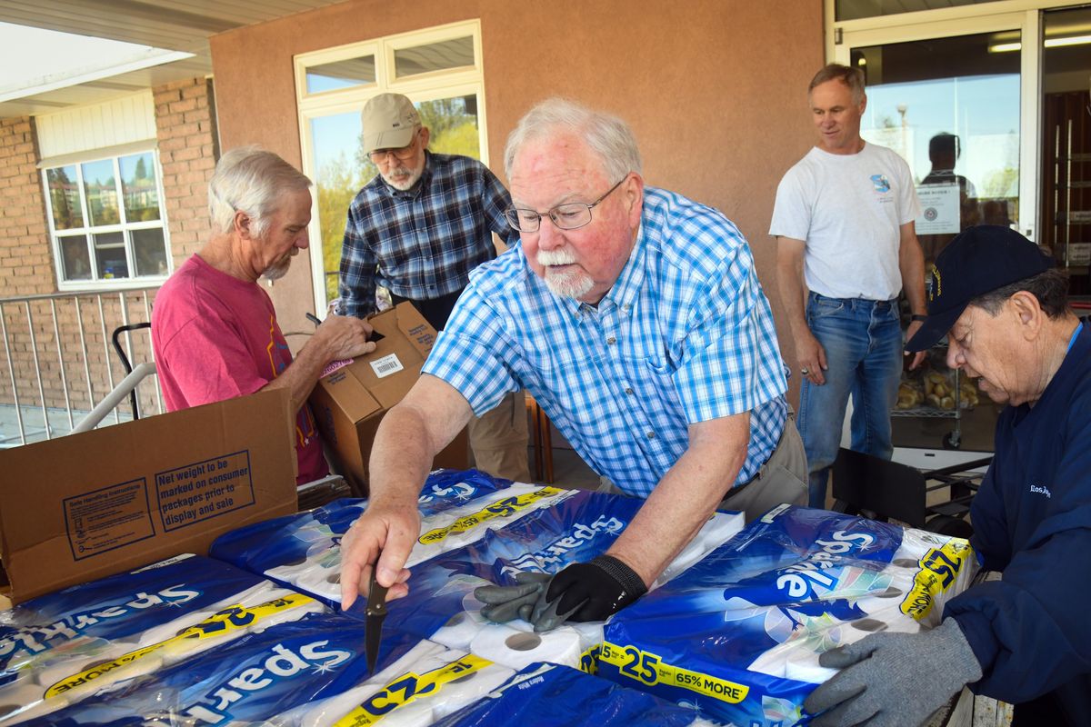 Caritas Food Bank volunteers, from, left, Paul Anderson, Tom Morgan, Bob Walker, Mike De Greef and Manny Aguilar unload 2500 pounds of food and other items from Harvest Northwest, Monday, May 6, 2019, in Spokane, Wash. (Dan Pelle / The Spokesman-Review)