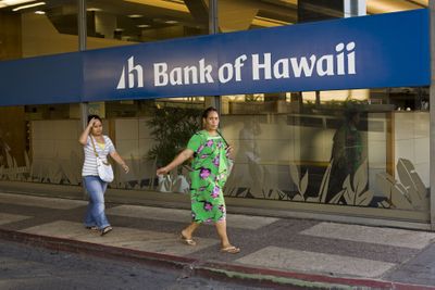 People walk past the Bank of Hawaii in Honolulu. While large banks on the mainland have been struggling, banks on the islands have held to conservative principles and have so far avoided the economic woes of the subprime mortgage fallout. (File Associated Press / The Spokesman-Review)