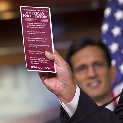House Speaker John Boehner holds up a card June 1 highlighting his plan to create jobs. House Majority Leader Eric Cantor looks on in the background. (Associated Press)