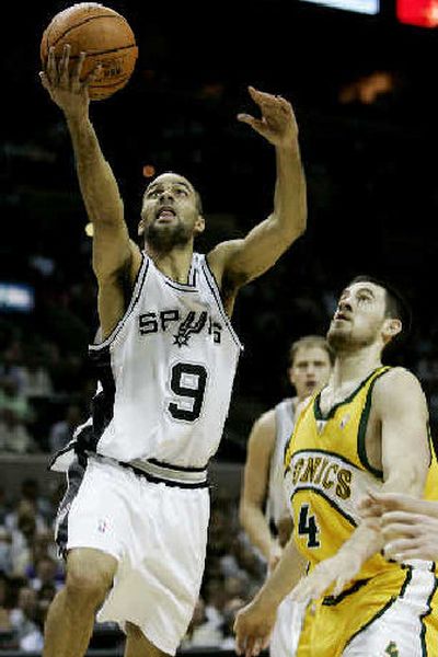 
Spurs' Tony Parker slips past Sonics' Nick Collison to score.
 (Associated Press / The Spokesman-Review)