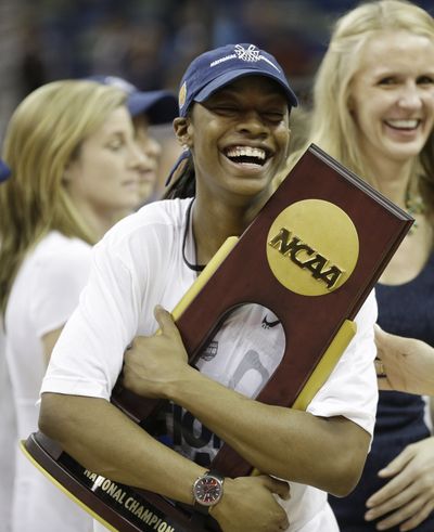 Connecticut’s Brianna Banks hugs women’s championship trophy. (Associated Press)