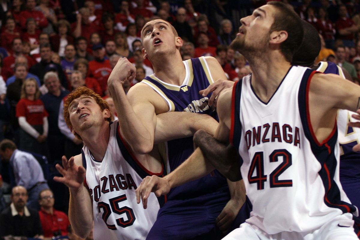 Washington’s Hans Gasser, center, struggles as he goes up to score after pushing past Gonzaga’s David Pendergraft (25) and Josh Heytvelt (42) during their matchup at McCarthy Center on Dec. 9, 2006. The Zags won 97-77.  (Amanda Smith/The Spokesman-Review)