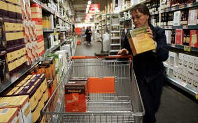 
Marina Carels, the deputy director of a local school, puts a box of Australian wine into her cart while shopping at a Colruyt supermarket in Dworp, Belgium. Part self-defeating, part conquered by ambitious New World producers, traditional European winemakers are in a rut, facing overcapacity, slinking markets and picky wine drinkers. Associated Press
 (Associated Press / The Spokesman-Review)