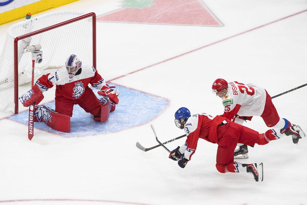 Russia forward Danil Bashkirov (25) is stopped by Czech Republic goalie Lukas Parik (1) as defenseman David Jiricek (8) defends during the first period of an IIHF World Junior Hockey Championship game in Edmonton, Alberta, on Sunday, Dec. 27, 2020.  (Canadian Press via AP)