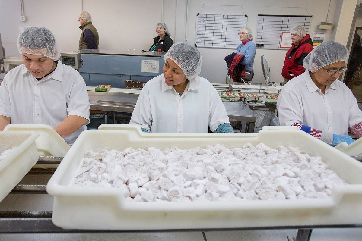 Liberty Orchards, home of Aplets and Cotlets, is known for tours of its Cashmere, Wash., production facility where visitors like these in 2014 watch candies being made and packaged from start to finish.  (Don Seabrook/Wenatchee World)