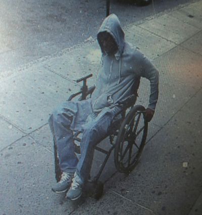 A photo from the New York Police Department shows a suspect getting away after a Santander Bank robbery in Queens borough. (Associated Press)