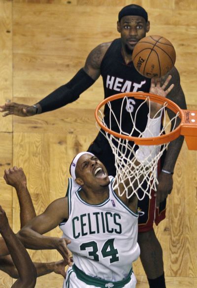 Celtics forward Paul Pierce drives to the basket past Heat’s LeBron James. (Associated Press)