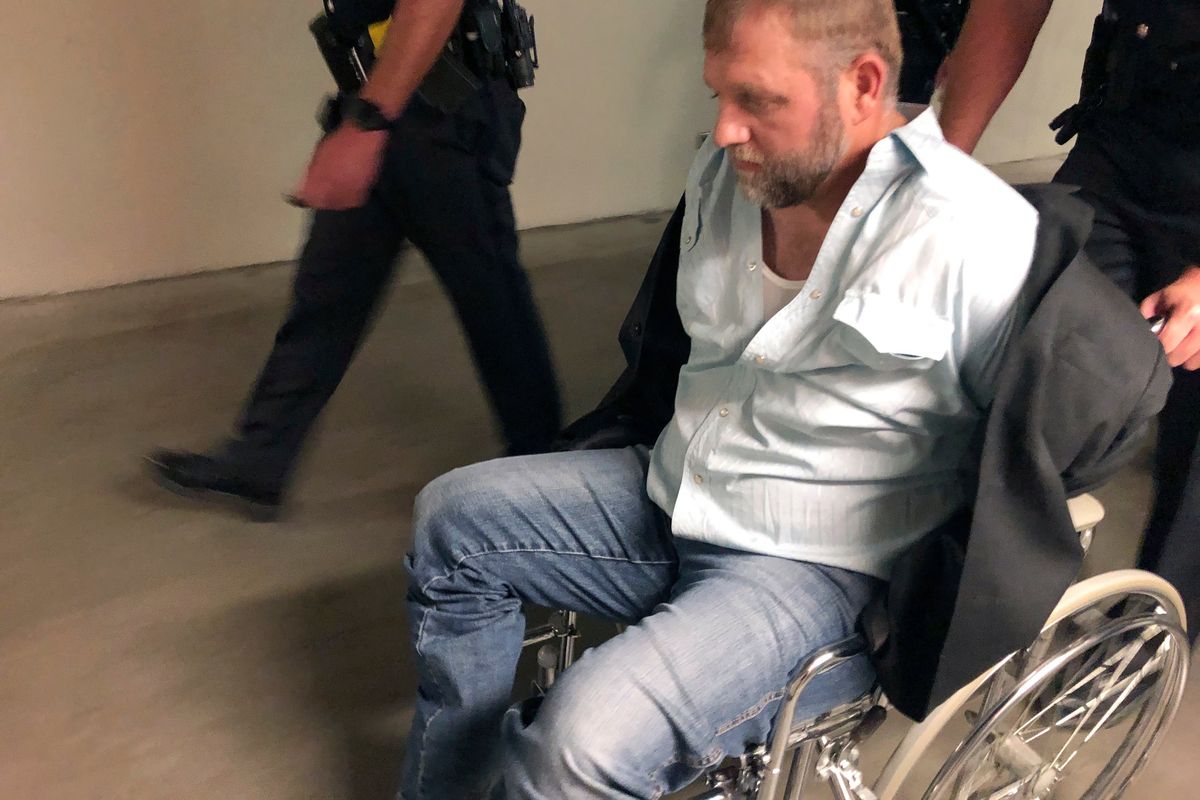 Anti-government activist Ammon Bundy is wheeled from the Idaho Statehouse in Boise, Idaho, on Aug. 26, 2020, following his second arrest for trespassing. Bundy says the hours he spent campaigning to be the next governor of Idaho should count toward his community service requirement.  (Keith Ridler)