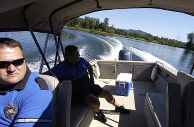 
Coeur d'Alene tribal police officers Rich Wienclaw, left, and Tom Bob patrol the St. Joe River near the southern end of Lake Coeur d'Alene Friday afternoon. The lake cops generally don't give citations unless the offense is egregious and spend most of their time doing 