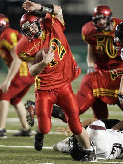 
SJE's Phillip Luft steps over Lummi's Isaac Finkbonner. 
 (Associated Press / The Spokesman-Review)