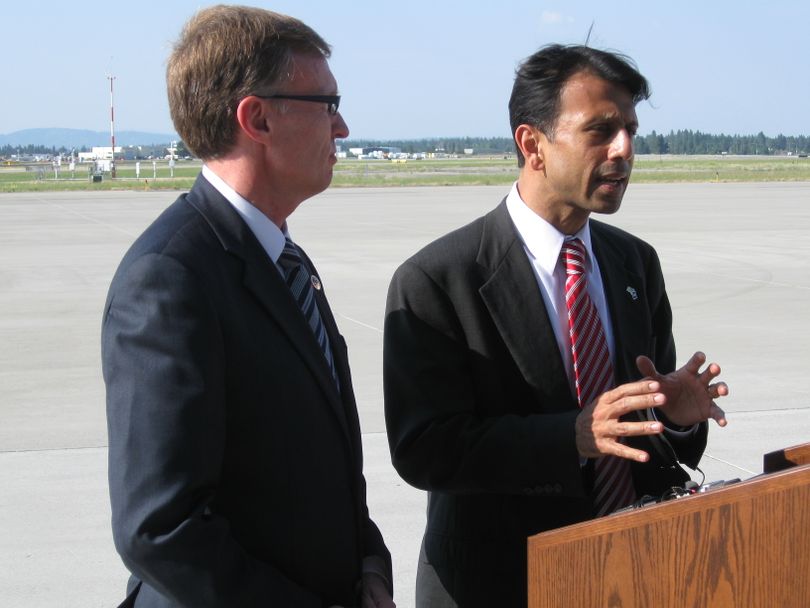 Louisiana Gov. Bobby Jindal, right, speaks to reporters Wednesday with the Republican frontrunner for Washington governor, Attorney General Rob McKenna, upon arriving by private plane to the Spokane International Airport at the XN Air terminal. Jindal was headed to a McKenna fund-raiser in Spokane. (Jonathan Brunt)