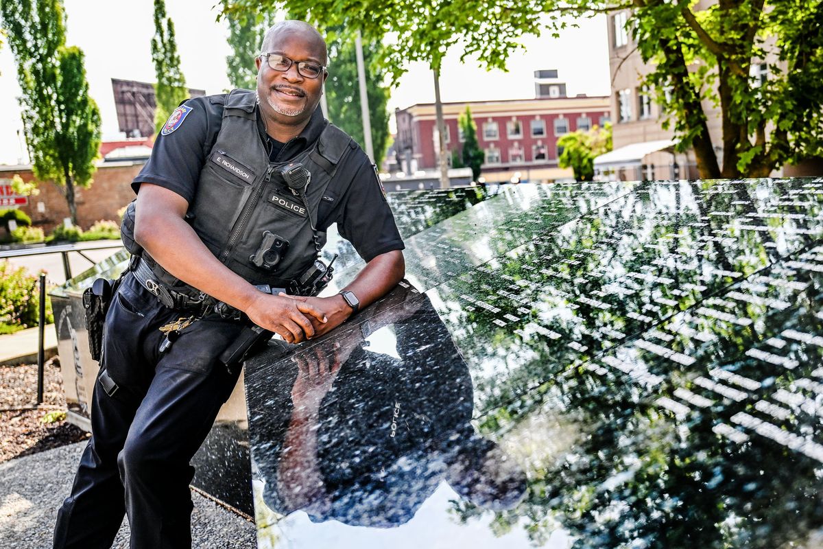 Spokane Police officer Ed Richardson talks about the Kindness 911 initiative Tuesday in front of the Spokane Regional Law Enforcement Memorial. (Kathy Plonka/The Spokesman-Review)