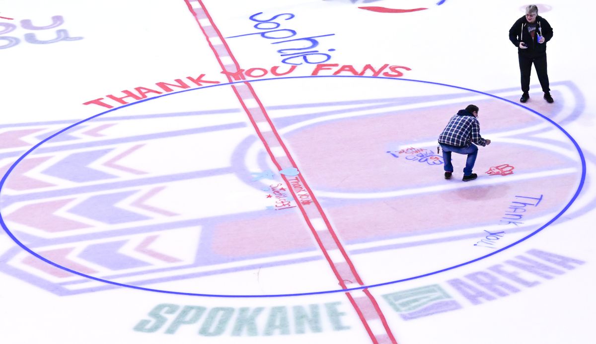 Jean Ripley, right, laughs as her husband, Kurt Ripley, left, paints during an ice painting event as the Spokane Chiefs close out the 2022-23 season on Friday, March 31, 2023, at Spokane Arena in Spokane, Wash.  (Tyler Tjomsland/The Spokesman-Review)