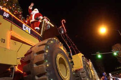 
Santa makes tracks along Sherman Avenue in downtown Coeur d'Alene on Friday night during the annual Christmas parade. 
 (Brian Plonka / The Spokesman-Review)