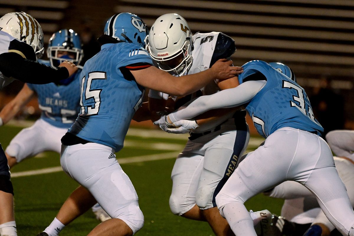 Mead’s Caleb Shawen battles for extra yards against host Central Valley in a Greater Spokane League game March 5.  (Colin Mulvany/THE SPOKESMAN-REVIEW)