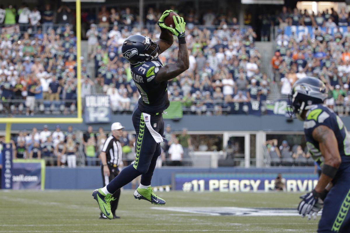 Seattle Seahawks strong safety Kam Chancellor pulls down an interception in the second half of an NFL football game against the Denver Broncos, Sept. 21, 2014, in Seattle. (Elaine Thompson / Associated Press)