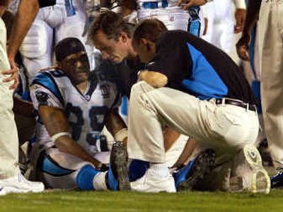 Trainers tend to Panthers wide receiver Steve Smith after he broke his leg in the fourth quarter of a loss to the Packers on Monday night.
(Associated Press / The Spokesman-Review)