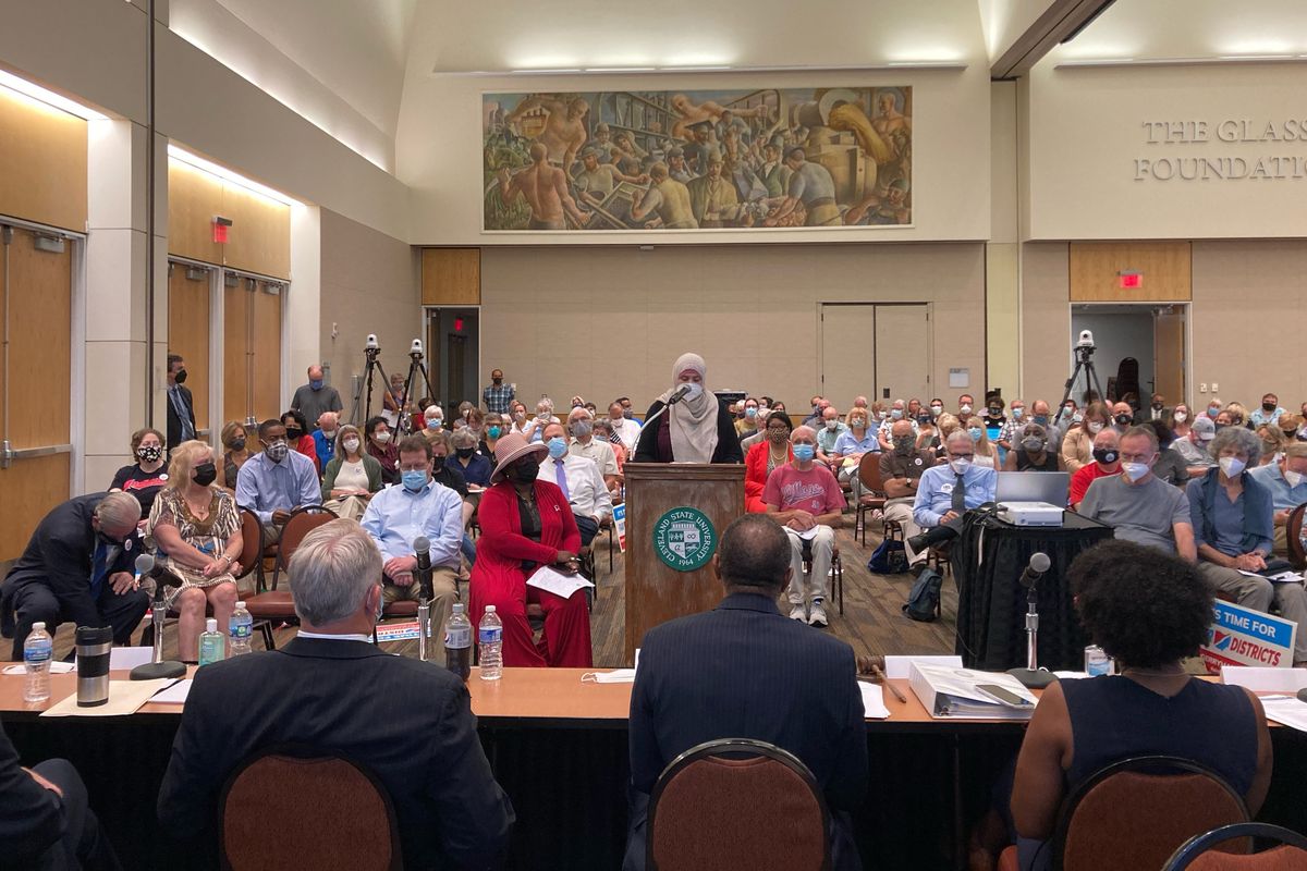 In this Aug. 23, 2021 photo, Areeqe Hammad, of Cleveland, testifies at the first public hearing of the Ohio Redistricting Commission at Cleveland State University in Cleveland. A new voter-approved commission in Ohio that was supposed to reduce partisanship in the once-a-decade process of political map-drawing has already become a flop. Similar commissions meeting for the first time in New York and Virginia have devolved into partisan finger-pointing, undermining their intent.  (Julie Carr Smyth)
