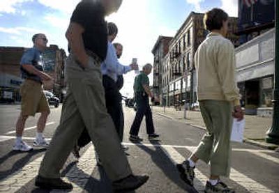 
Area residents and planners cross Main Street at Browne during a tour before a workshop at Gonzaga University on Saturday. The tour highlighted natural and historic points of interest and  ideas for development of the district. 
 (Holly Pickett / The Spokesman-Review)