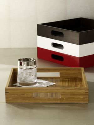 This undated photo provided by West Elm shows square wood trays for TV dining.   (Associated Press / The Spokesman-Review)